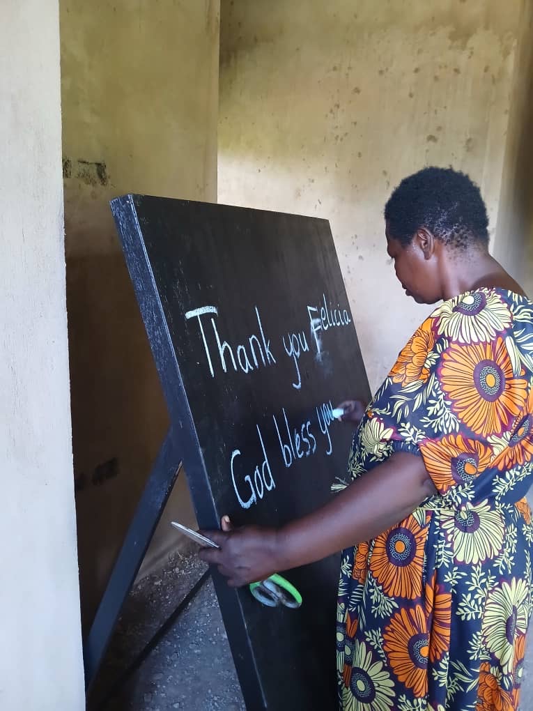 teacher writing on chalkboard